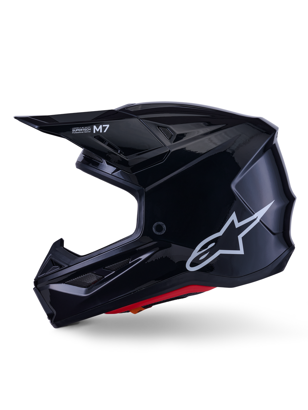 Casco Alpinestars S-M7 Solid, casco da motocross nero lucido, profilo laterale con logo Alpinestars bianco, calotta aerodinamica con rete di ventilazione e imbottitura interna rossa, protezione avanzata per il fuoristrada