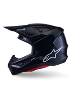 Casco Alpinestars S-M7 Solid, casco da motocross nero lucido, profilo laterale con logo Alpinestars bianco, calotta aerodinamica con rete di ventilazione e imbottitura interna rossa, protezione avanzata per il fuoristrada