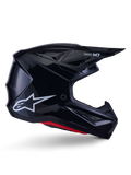 Alpinestars S-M7 Solid Helmet, casco da motocross, nero lucido con logo a stella bianco e dettagli rossi, profilo laterale con design aerodinamico, prese d'aria in rete e branding Supertech M7 sulla visiera