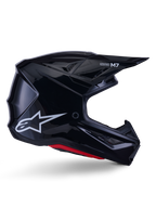 Alpinestars S-M7 Solid Helmet, casco da motocross, nero lucido con logo a stella bianco e dettagli rossi, profilo laterale con design aerodinamico, prese d'aria in rete e branding Supertech M7 sulla visiera