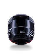 Casco Alpinestars S-M7 Solid ECE 22.06, casco da motocross, nero lucido, vista posteriore con loghi a stella bianchi, calotta aerodinamica in composito con finitura lucida, etichette di certificazione di sicurezza e taglia al centro