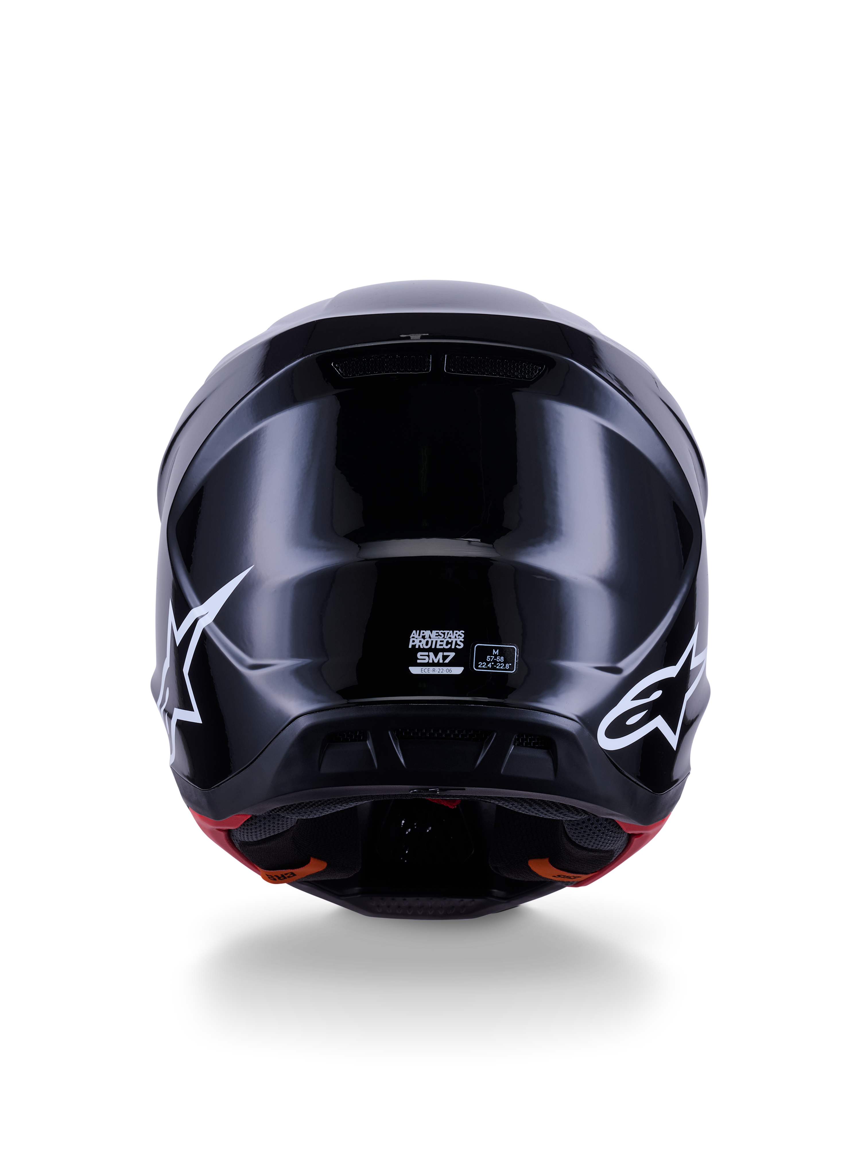 Casco Alpinestars S-M7 Solid ECE 22.06, casco da motocross, nero lucido, vista posteriore con loghi a stella bianchi, calotta aerodinamica in composito con finitura lucida, etichette di certificazione di sicurezza e taglia al centro