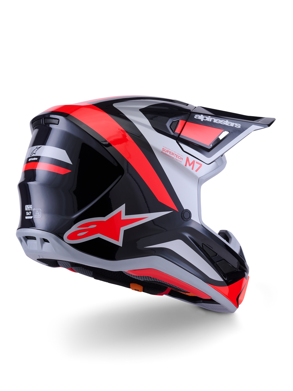 Casco Alpinestars S-M7 Rise, casco da motocross, nero, argento e rosso fluo lucido, vista posteriore di tre quarti, con logo A-star rosso e accenti argento, calotta aerodinamica con visiera, protezione professionale per il fuoristrada