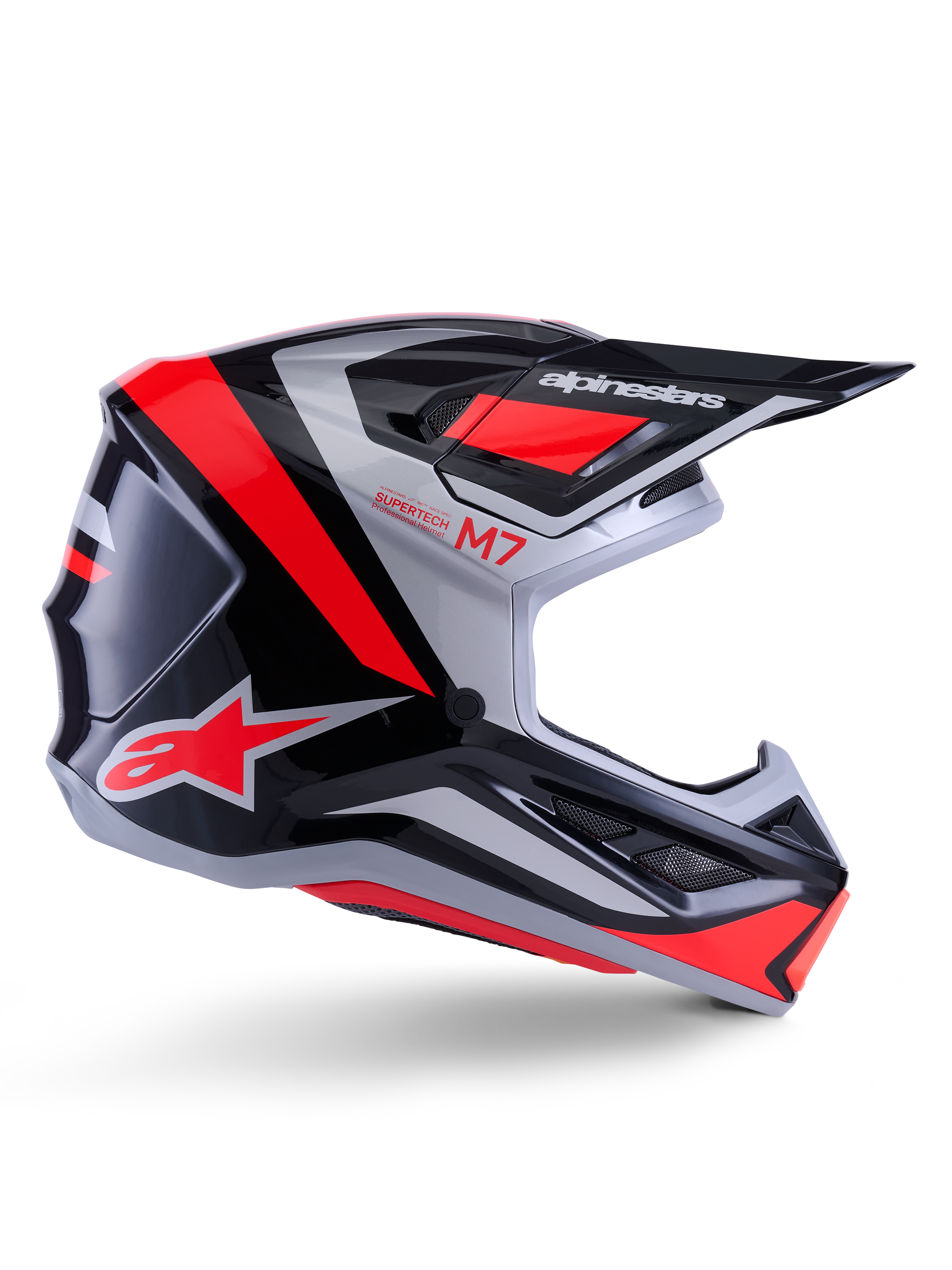 Casco Alpinestars S-M7 Rise, casco da motocross, nero, argento e rosso fluo, vista laterale con design aerodinamico angolare, visiera e prese d'aria, finitura lucida, serie Supertech M7