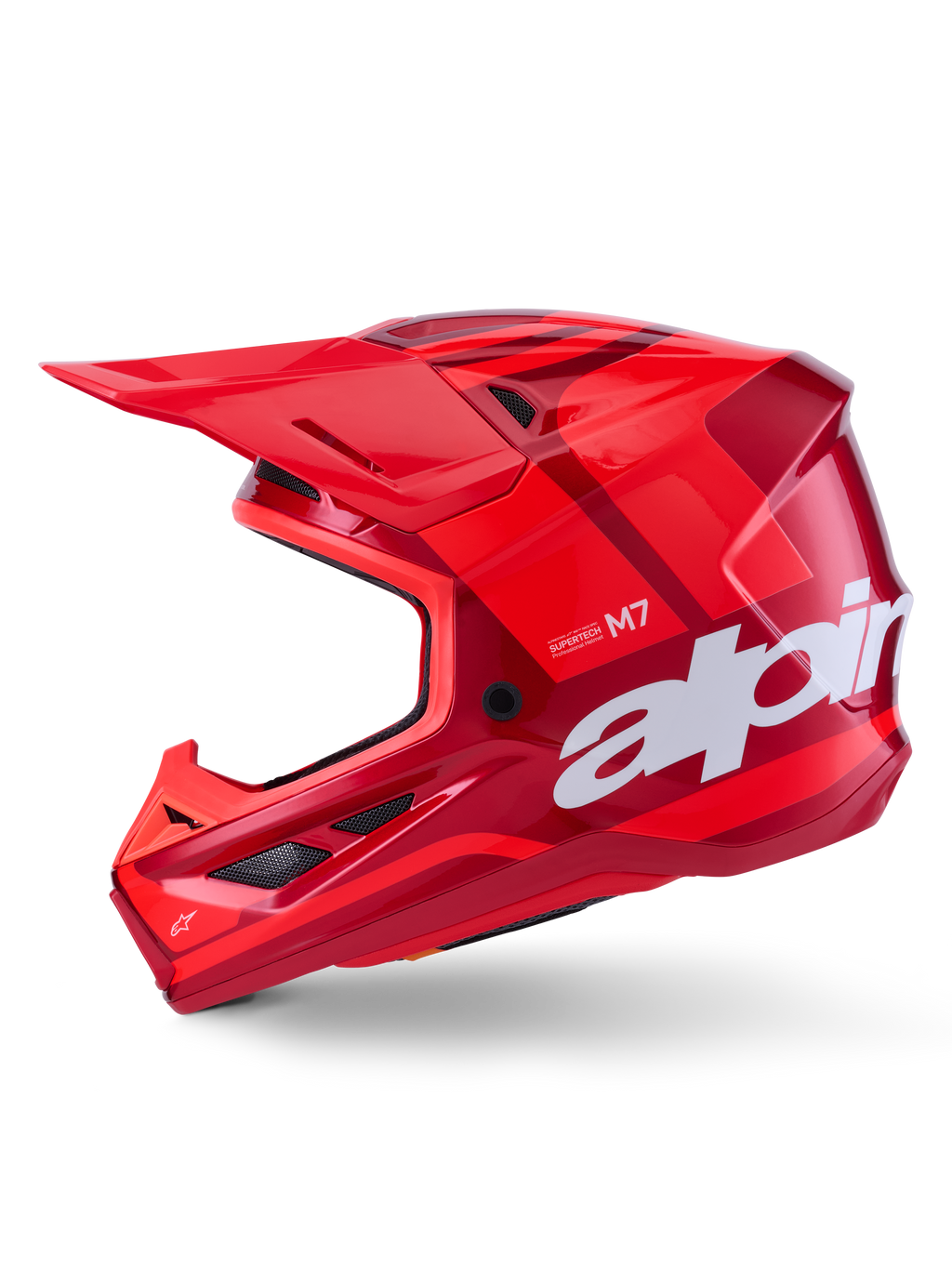 Casco Alpinestars S-M7 Core, rosso lucido con accenti geometrici, casco da motocross, vista laterale, calotta aerodinamica con prese d'aria e loghi bianchi, equipaggiamento professionale per fuoristrada
