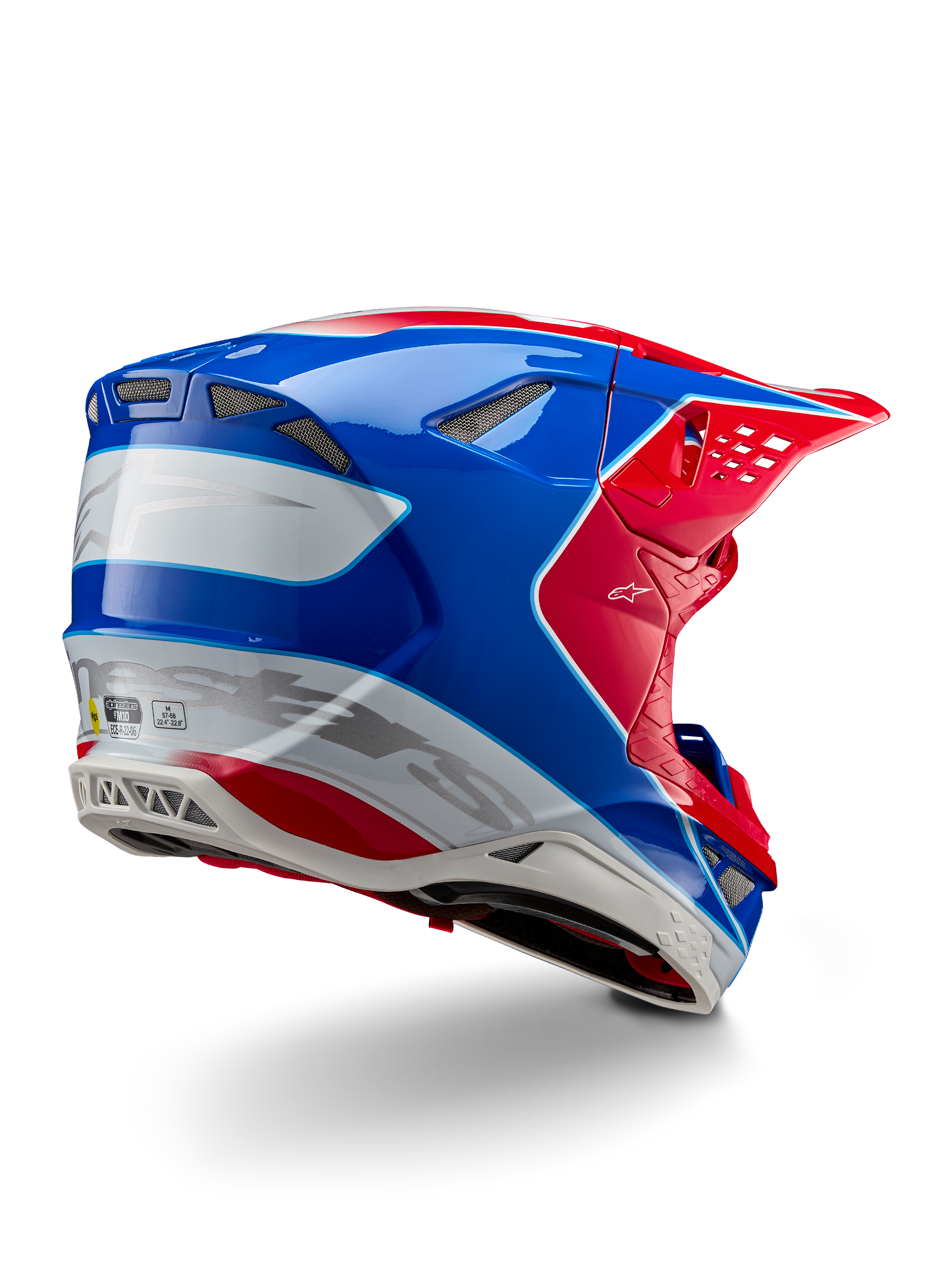 Casco Alpinestars Supertech M10 Aeon ECE 22.06, casco da motocross, rosso acceso, blu e bianco lucido, vista laterale posteriore con profilo aerodinamico, marchio Alpinestars argento e prese d'aria integrate.