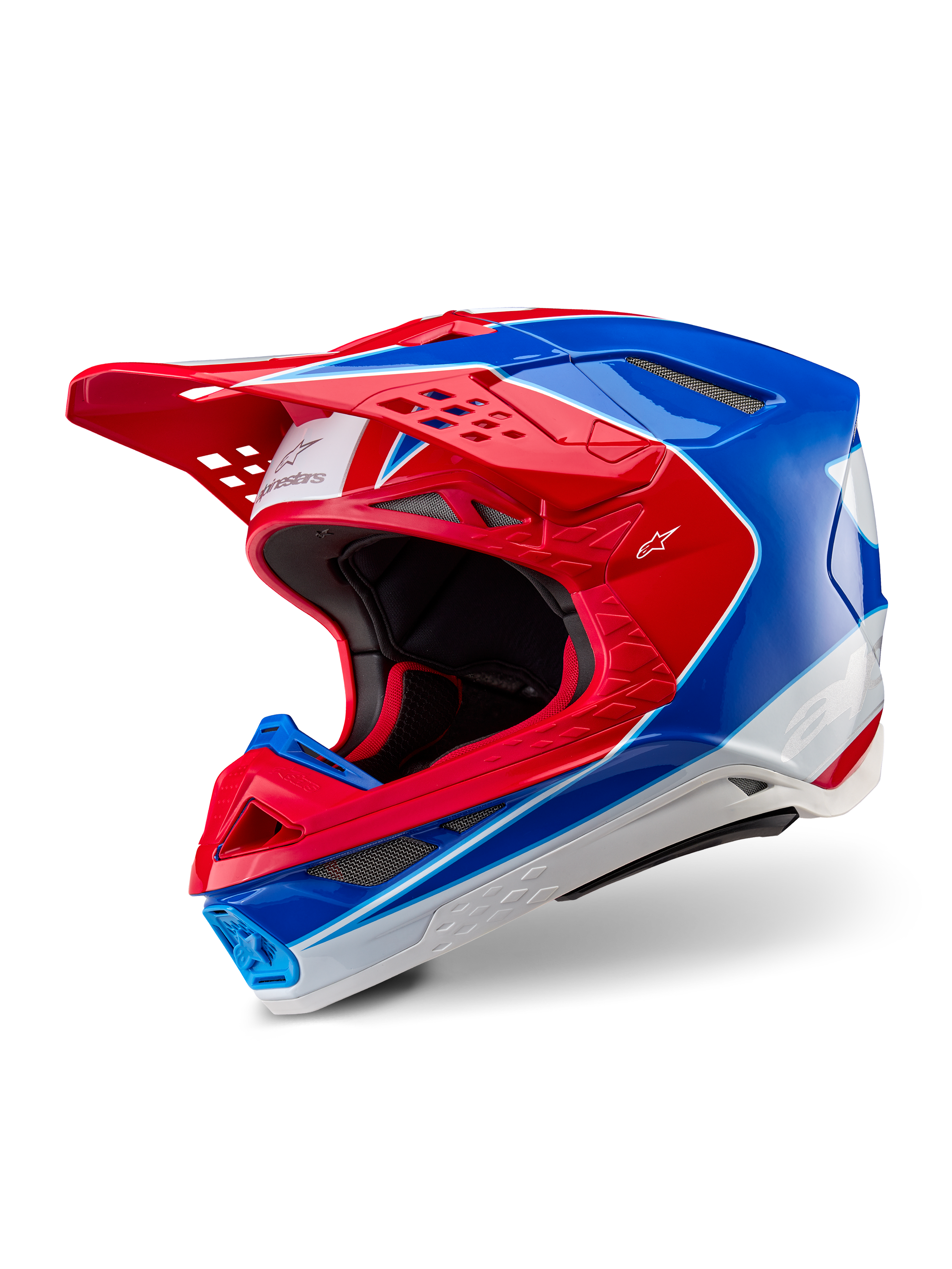 Casco Alpinestars Supertech M10 Aeon, casco da motocross, rosso e blu lucido, vista a tre quarti che mostra la calotta aerodinamica con prese d'aria multiple, accenti grafici bianchi e rossi, logo Alpinestars sulla visiera e sul lato, equipaggiamento professionale per gare fuoristrada