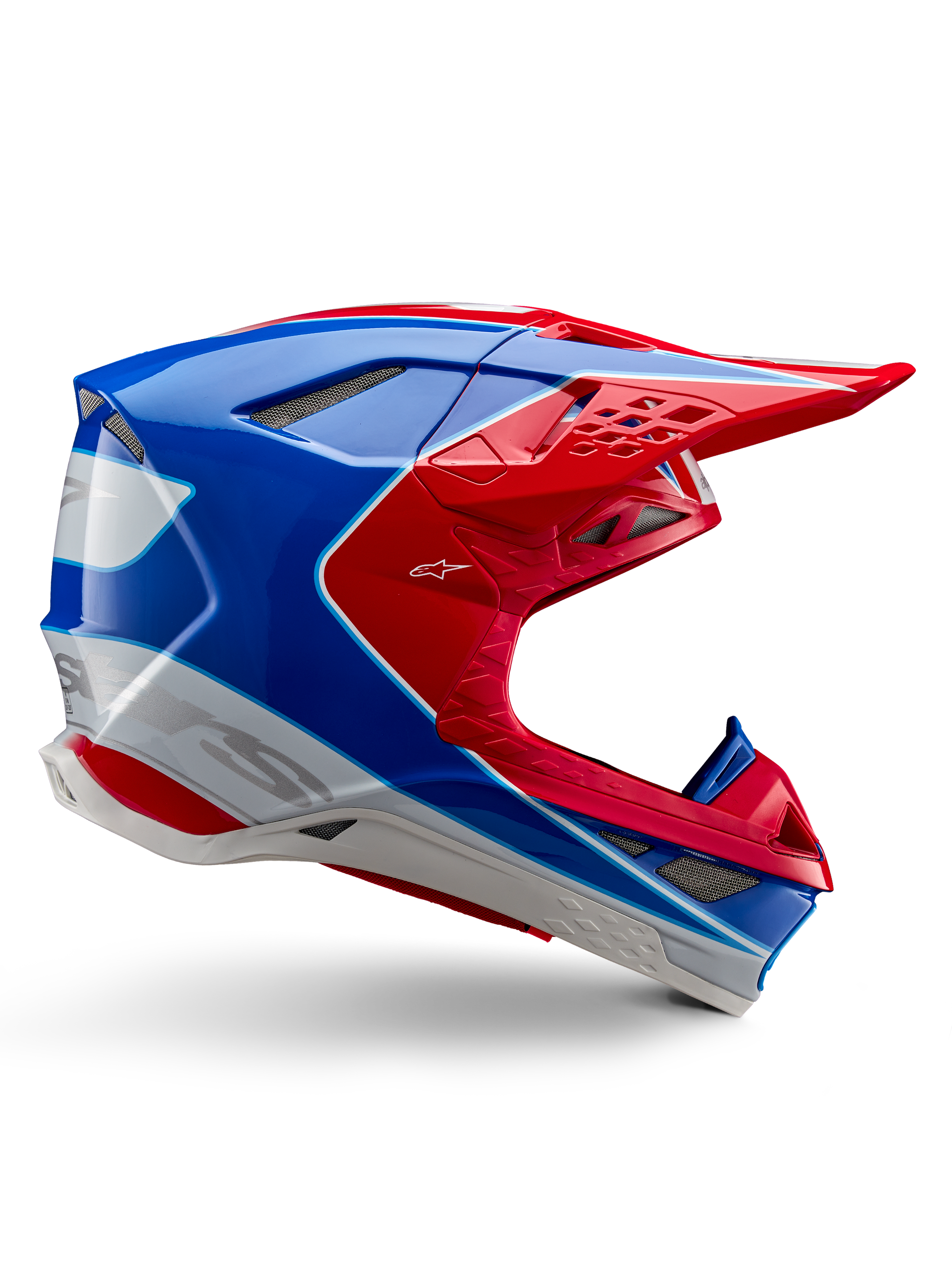 Alpinestars Supertech M10 Aeon, casco da motocross, rosso brillante, blu e bianco, finitura lucida, profilo laterale aerodinamico con molteplici prese d'aria coperte da rete, contorni angolari e visiera