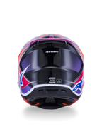 Casco Alpinestars S-M7 Fuse, casco da motocross, vista posteriore, blu viola rosa lucido, grafiche vivaci rosa e viola su calotta nera lucida, con prese d'aria ed etichetta di certificazione ECE 22.06