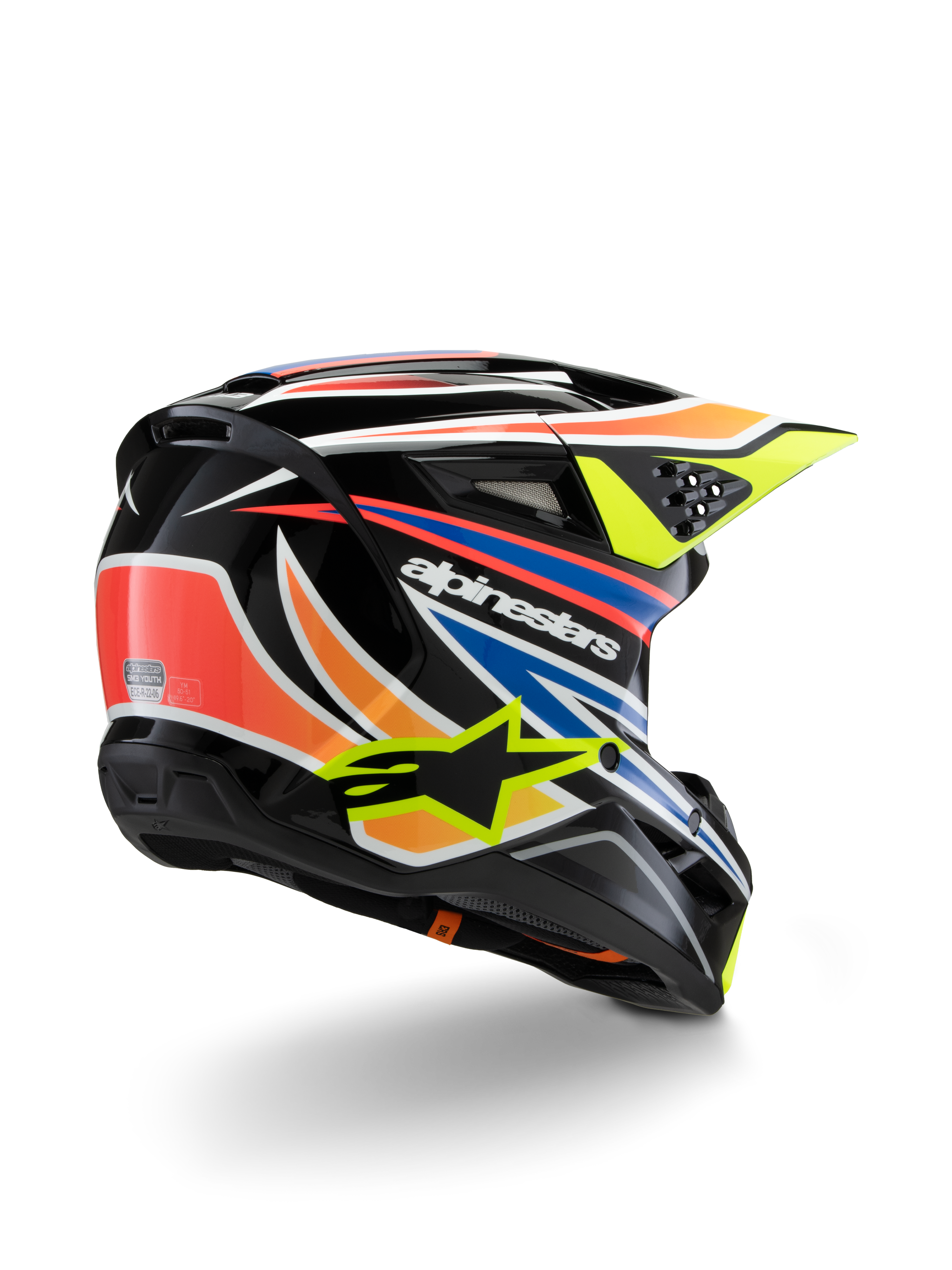 Casco Alpinestars S-M3 Youth Wurx, casco da motocross per ragazzi, nero con vivaci accenti arancione, rosso, blu e giallo fluorescente, vista posteriore a tre quarti che mostra la calotta aerodinamica e le porte di ventilazione, finitura lucida con logo Alpinestars in evidenza