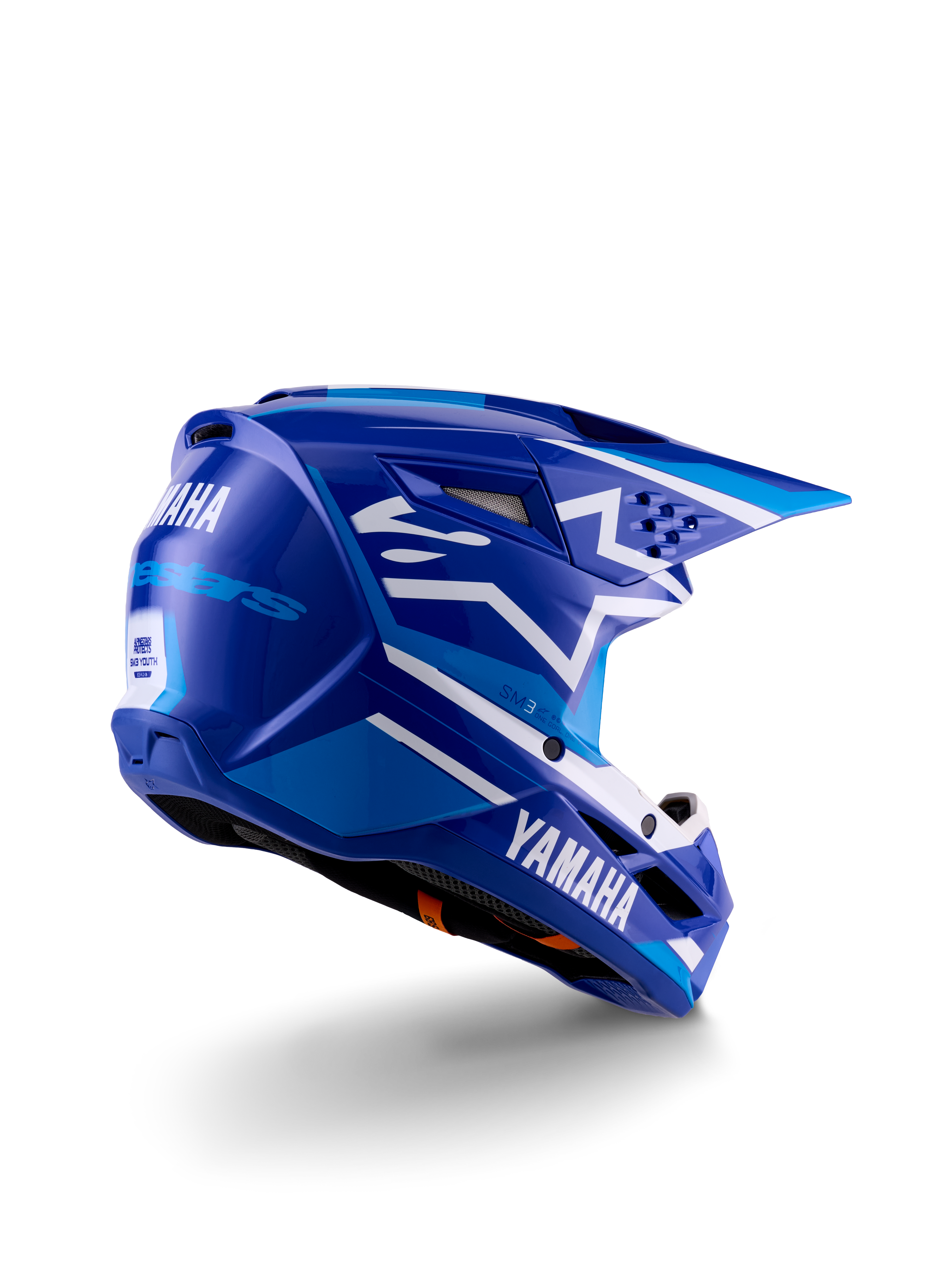 Casco da motocross Alpinestars Yamaha S-M3 per ragazzi, blu e bianco lucido, con marchio Yamaha evidente sul lato e sul retro, design aerodinamico della calotta con ventilazione posteriore, protezione per la testa off-road specifica per ragazzi in una vista posteriore a tre quarti.
