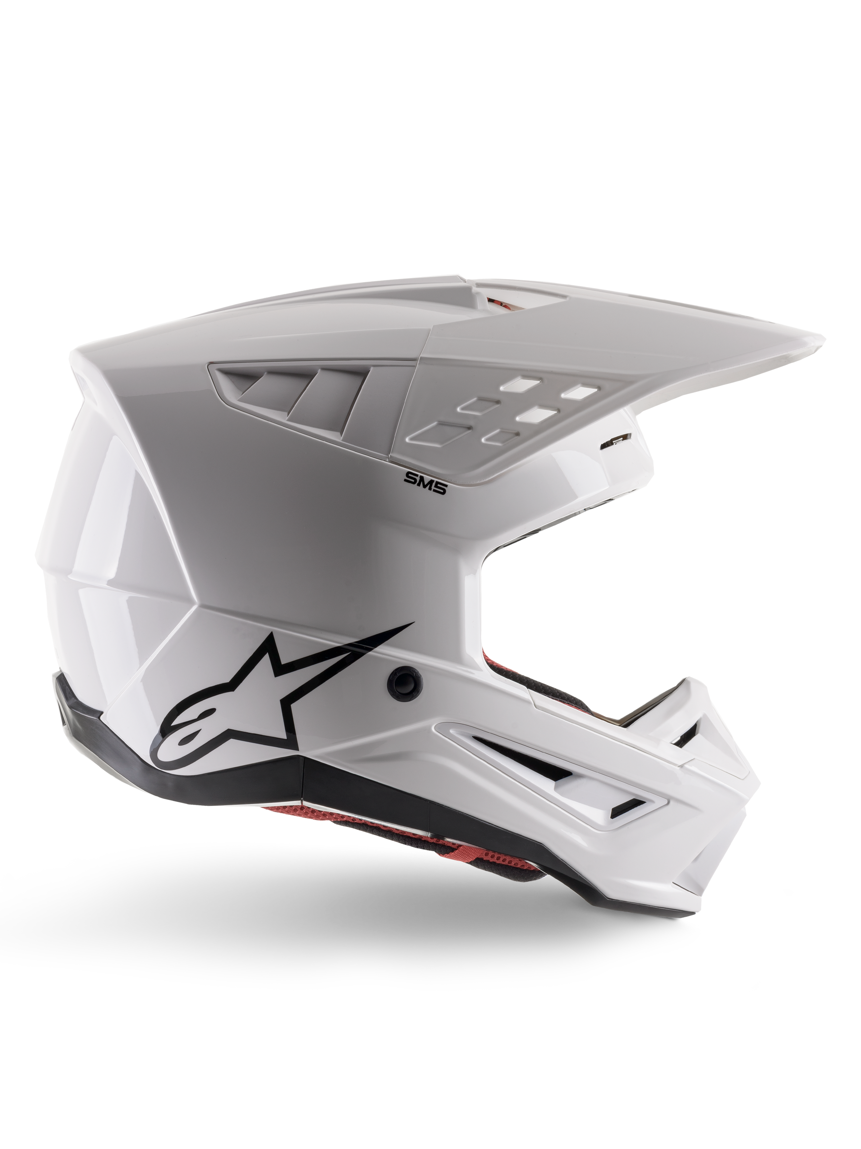 Alpinestars S-M5 Solid Helmet ECE 22.06, casco da motocross, bianco lucido, profilo laterale con design aerodinamico angolare, visiera prominente, prese d'aria integrate, logo Astars nero sul retro e imbottitura interna rossa visibile