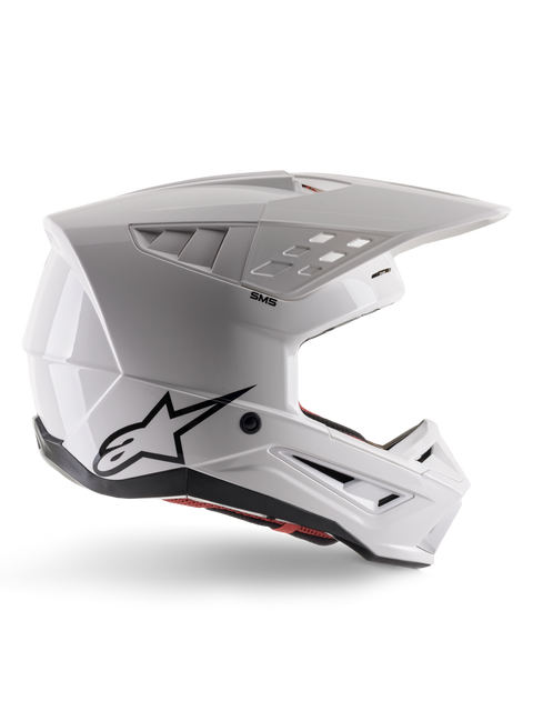 Alpinestars S-M5 Solid Helmet ECE 22.06, Motocross Helmet, White Glossy, side profile featuring an angular aerodynamic design, prominent peak visor, integrated air vents, black Astars logo on the rear, and visible red interior padding