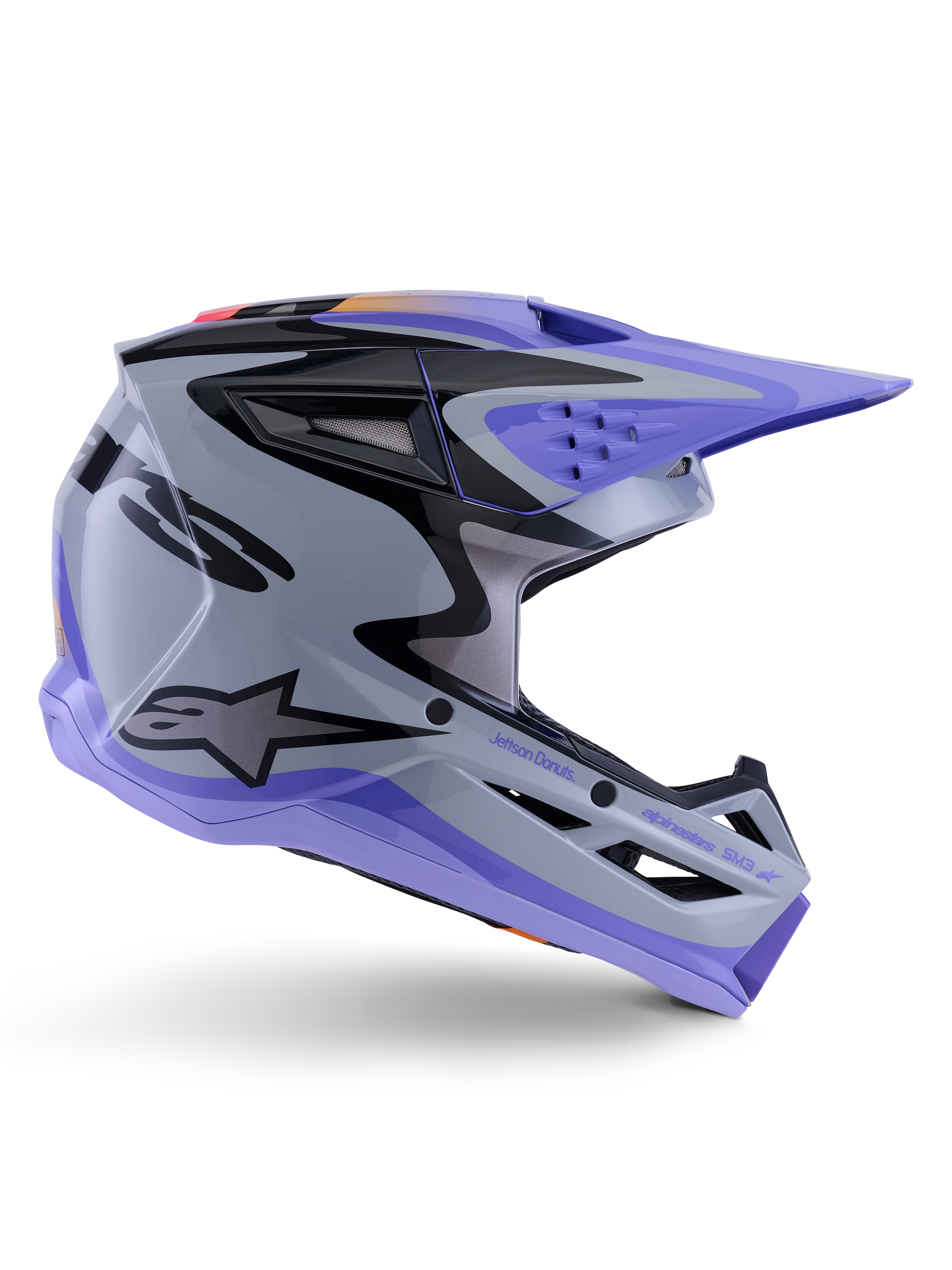 Casco Alpinestars S-M3 Jettson Youth, casco da motocross, grigio, viola e nero lucido, profilo laterale con grafiche angolari e marchio 'Jettson Donuts', design aerodinamico della calotta con prese d'aria e logo Alpinestars, attrezzatura protettiva off-road per ragazzi ad alte prestazioni