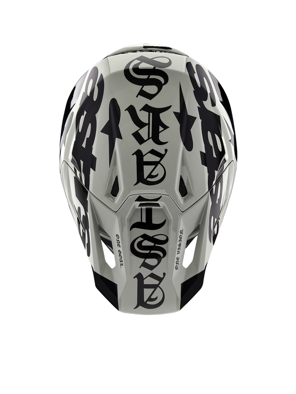 Casco Alpinestars Limited Edition S-M7 Wolf Dust, vista dall'alto, finitura lucida Dune e Nero, con un'audace tipografia in stile gotico sulla calotta e dettagli One Goal One Vision, protezione professionale per la testa da motocross