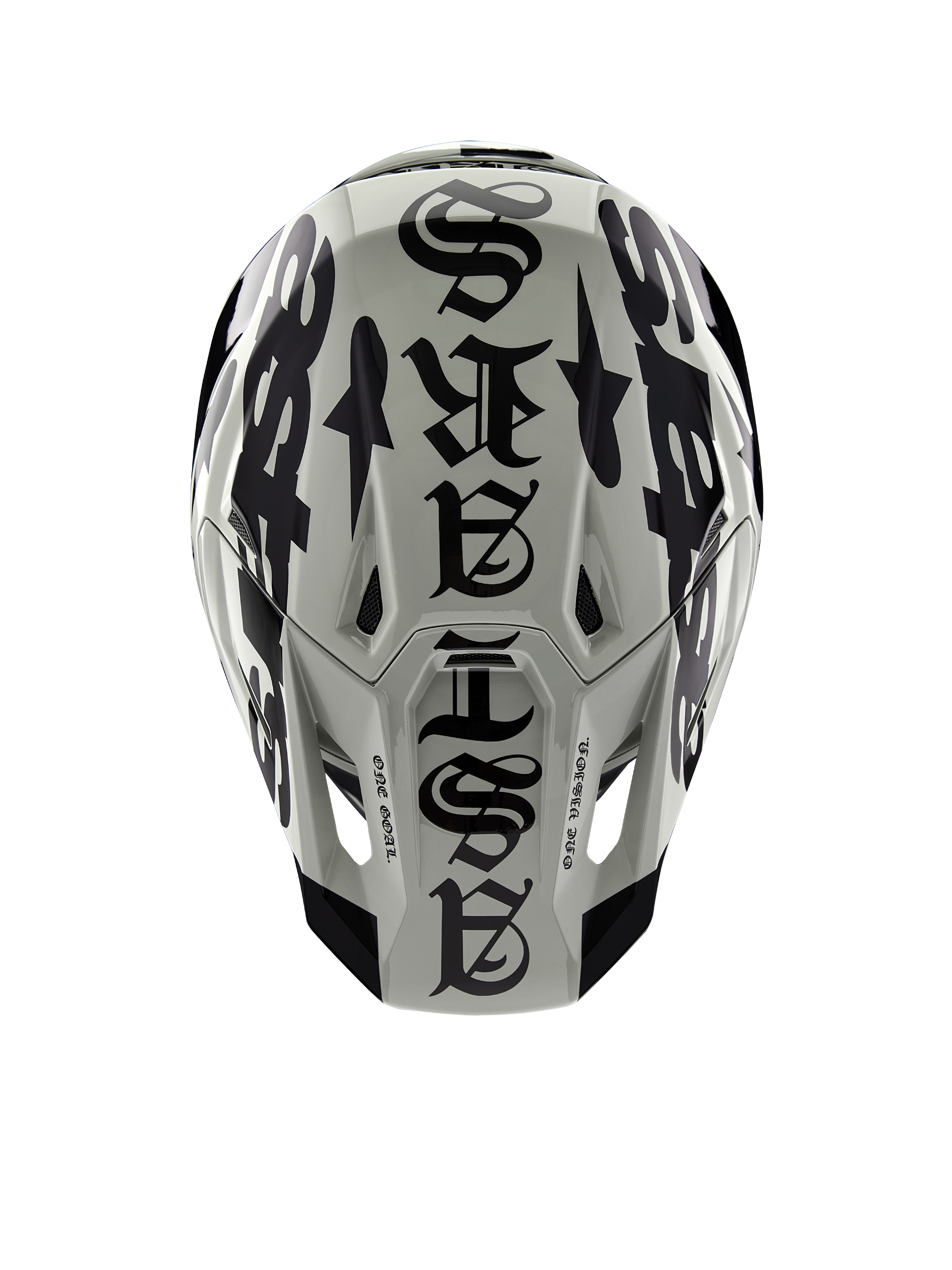 Casco Alpinestars Limited Edition S-M7 Wolf Dust, vista dall'alto, finitura lucida Dune e Nero, con un'audace tipografia in stile gotico sulla calotta e dettagli One Goal One Vision, protezione professionale per la testa da motocross