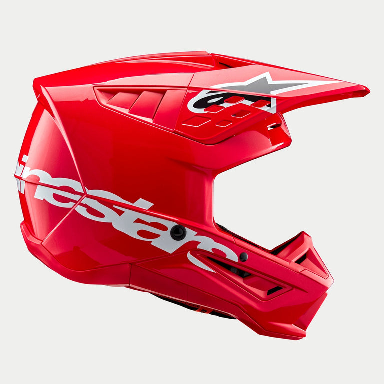 Alpinestars S-M5 Corp Helmet ECE, casco da motocross, rosso lucido, vista laterale di profilo che mostra un grande logo Alpinestars bianco sulla calotta inferiore, visiera aerodinamica ventilata con logo a stella e finitura lucida per la protezione nelle corse fuoristrada