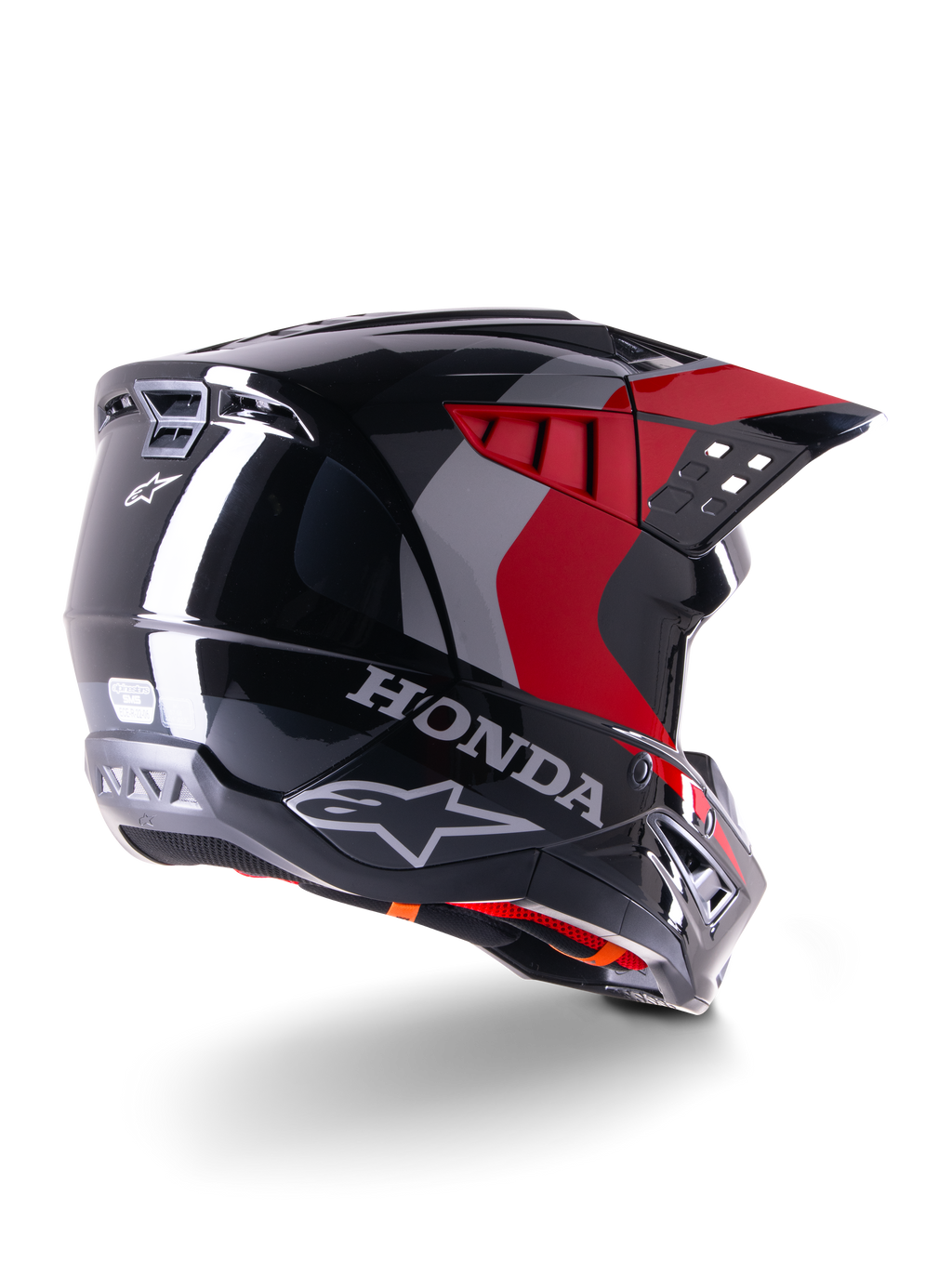 Casco Alpinestars Honda S-M5 ECE, casco da motocross, nero rosso lucido, vista posteriore di tre quarti con marchio Honda e loghi Alpinestars, finitura lucida con accenti grafici rossi e grigi, progettato per la protezione fuoristrada
