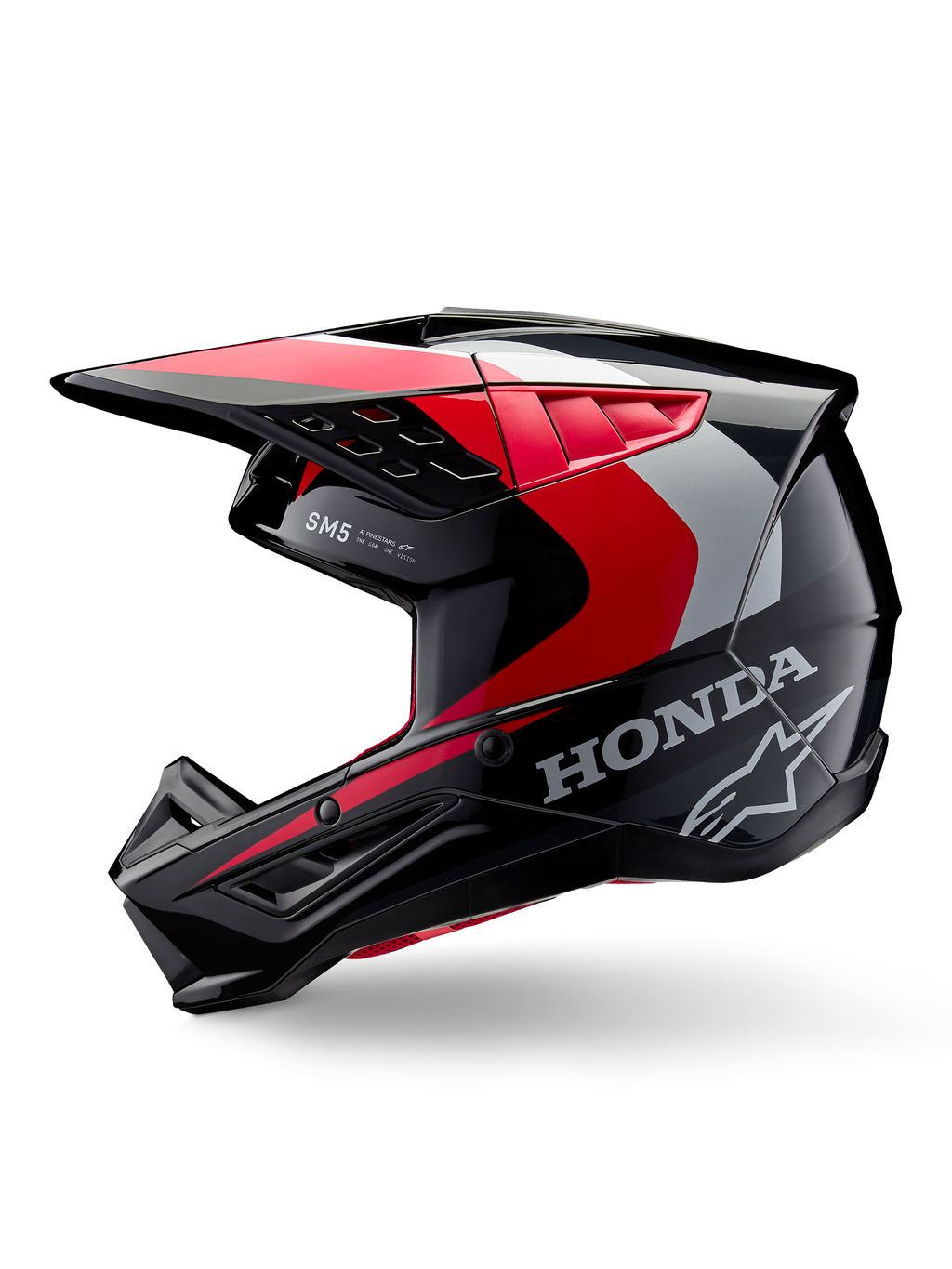 Casco Alpinestars Honda S-M5, casco da motocross, nero, rosso e argento lucido, vista laterale di profilo con marchio Honda e logo Alpinestars a stella, design aerodinamico con visiera integrata e prese d'aria per prestazioni off-road