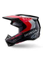 Casco Alpinestars Honda S-M5, casco da motocross, nero, rosso e argento lucido, vista laterale di profilo con marchio Honda e logo Alpinestars a stella, design aerodinamico con visiera integrata e prese d'aria per prestazioni off-road