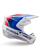 Alpinestars Honda S-M5 Helmet ECE, casco da motocross, bianco, blu e rosso, vista di profilo laterale, design aerodinamico con visiera integrata, molteplici aperture di ventilazione, finitura lucida, marchio Honda in evidenza e logo Alpinestars