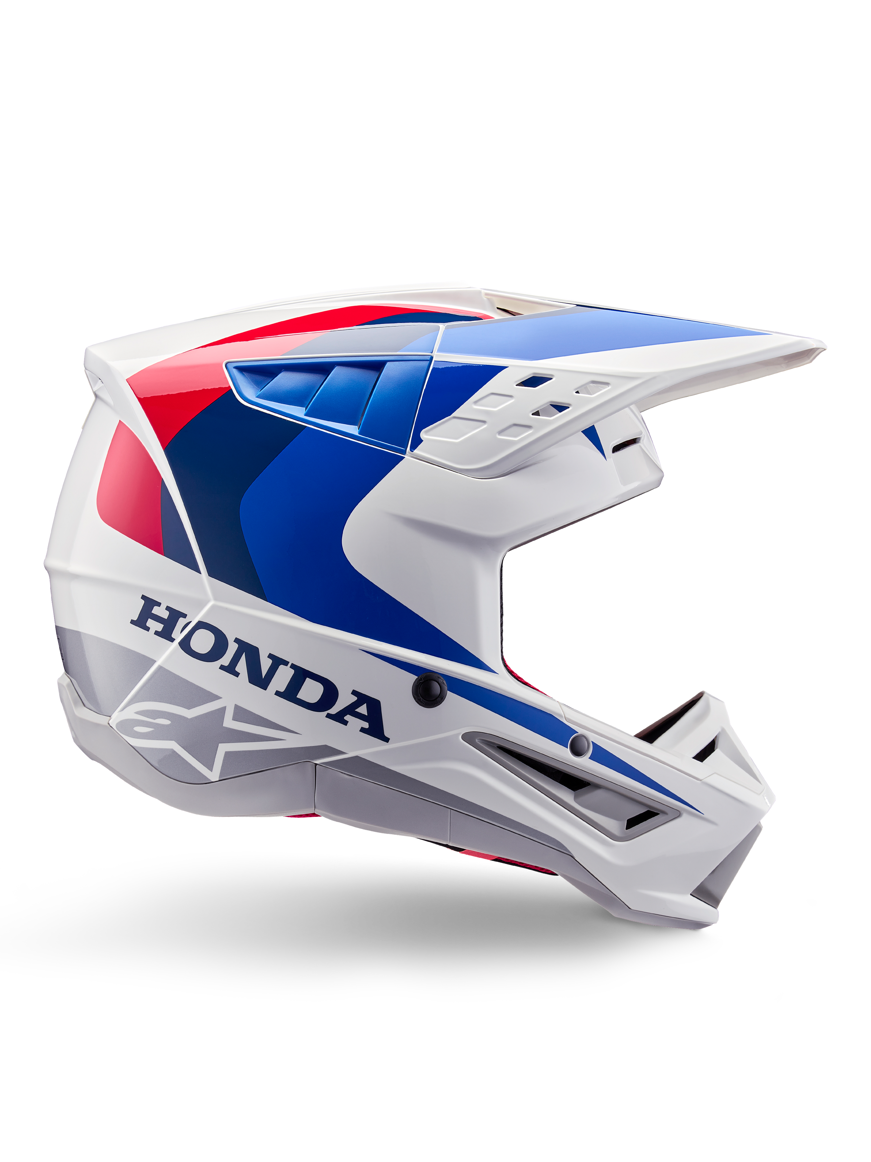 Alpinestars Honda S-M5 Helmet ECE, casco da motocross, bianco, blu e rosso, vista di profilo laterale, design aerodinamico con visiera integrata, molteplici aperture di ventilazione, finitura lucida, marchio Honda in evidenza e logo Alpinestars