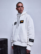 Alpinestars RSRV Rival Hoodie, felpa bianca con toppe nere, patch arancione, collo alto, abbigliamento streetwear premium, stile urbano