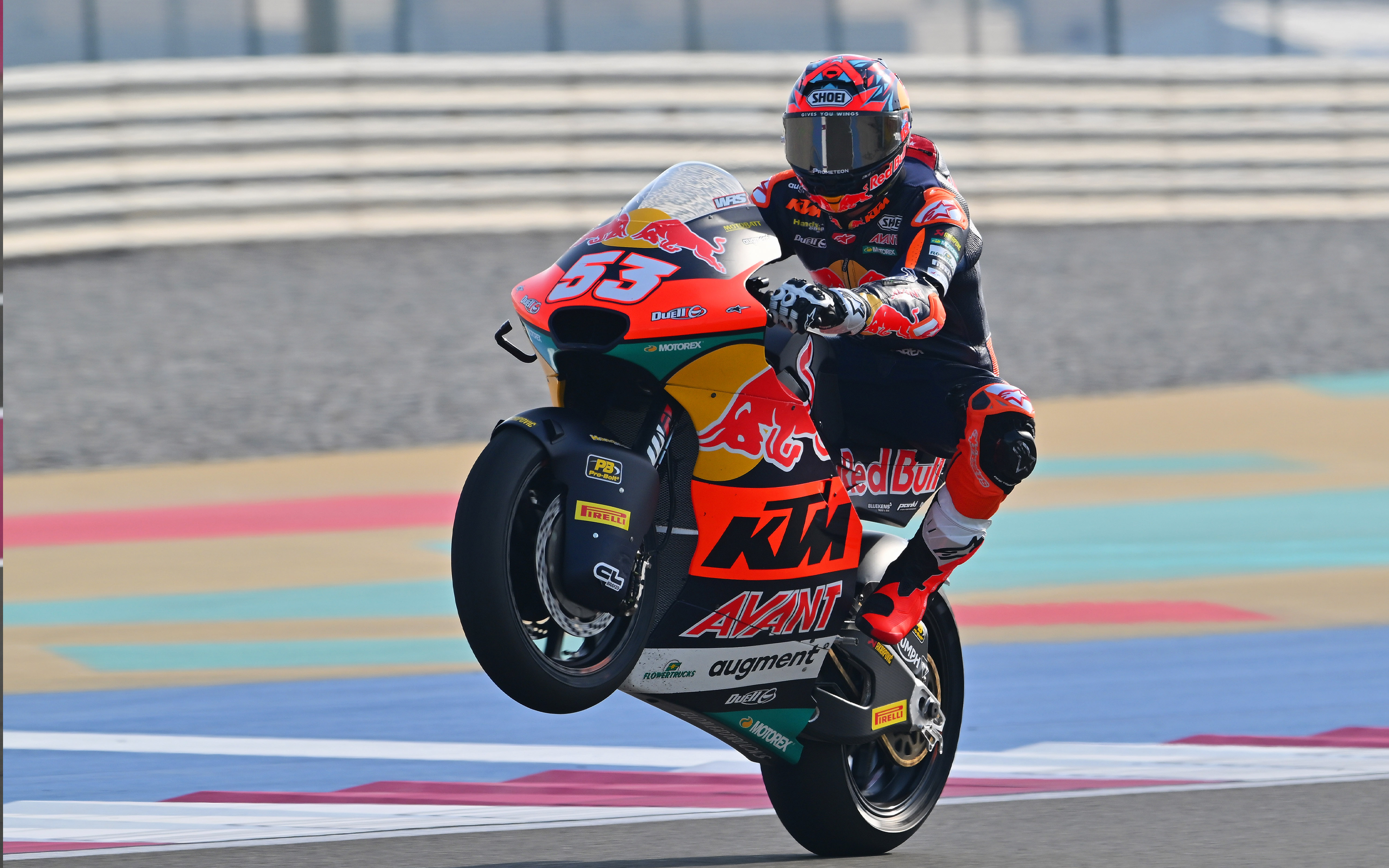 Motorcycle racer Deniz Oncu on a KTM bike with Red Bull and Alpinestars branding on a racetrack.