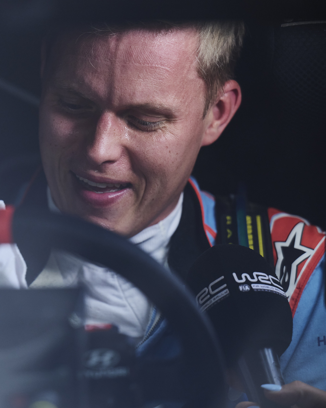 Ott Tanak getting interviewed in his car wearing an Alpinestars racing suit