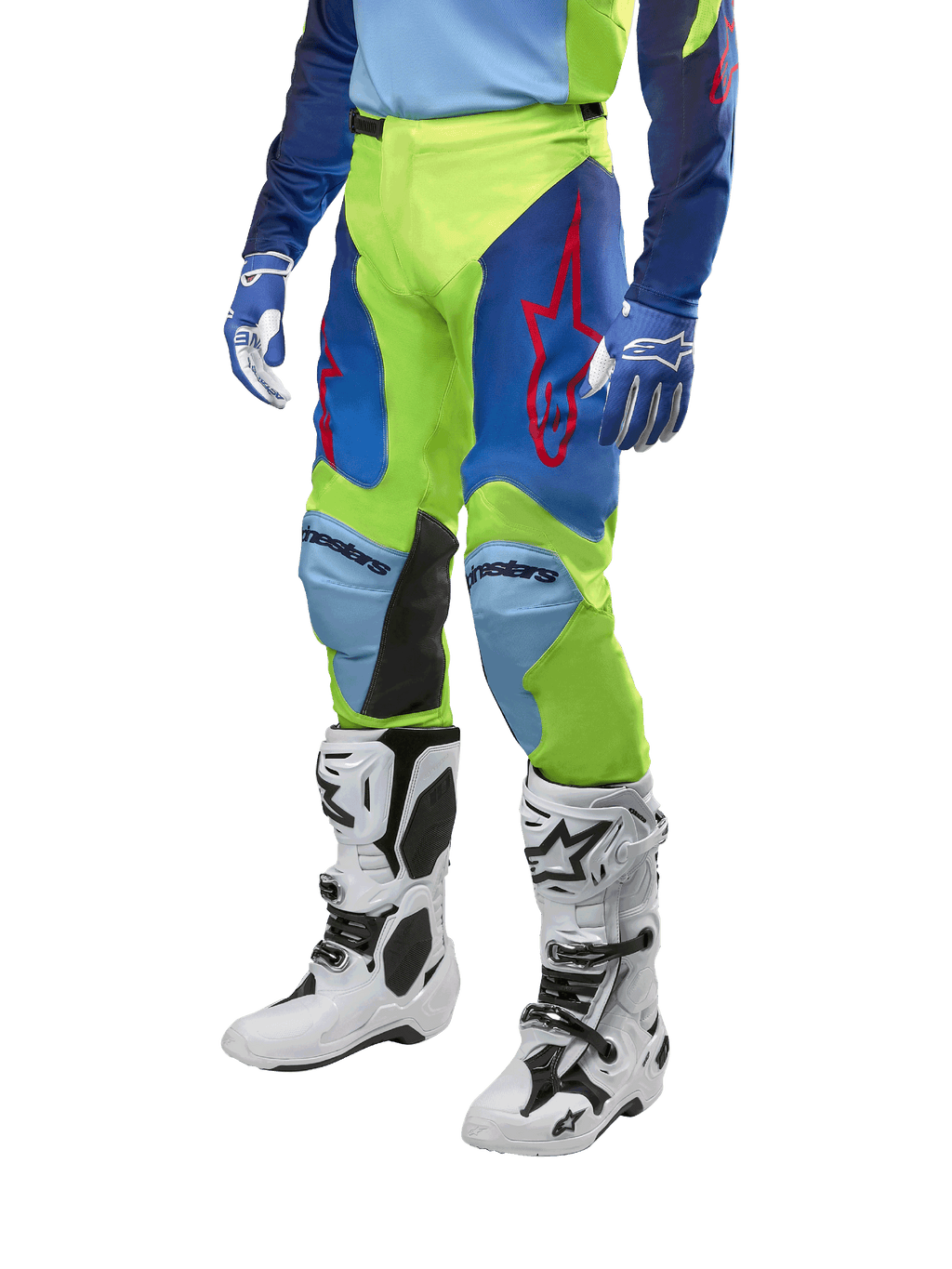 Pantaloni Alpinestars Racer Hoen 2024, pantaloni da motocross, giallo fluo e blu notte con loghi a stella rossi e pannelli interni neri alle ginocchia, indossati con maglia coordinata e stivali da motocross bianchi, abbigliamento tecnico per gare off-road