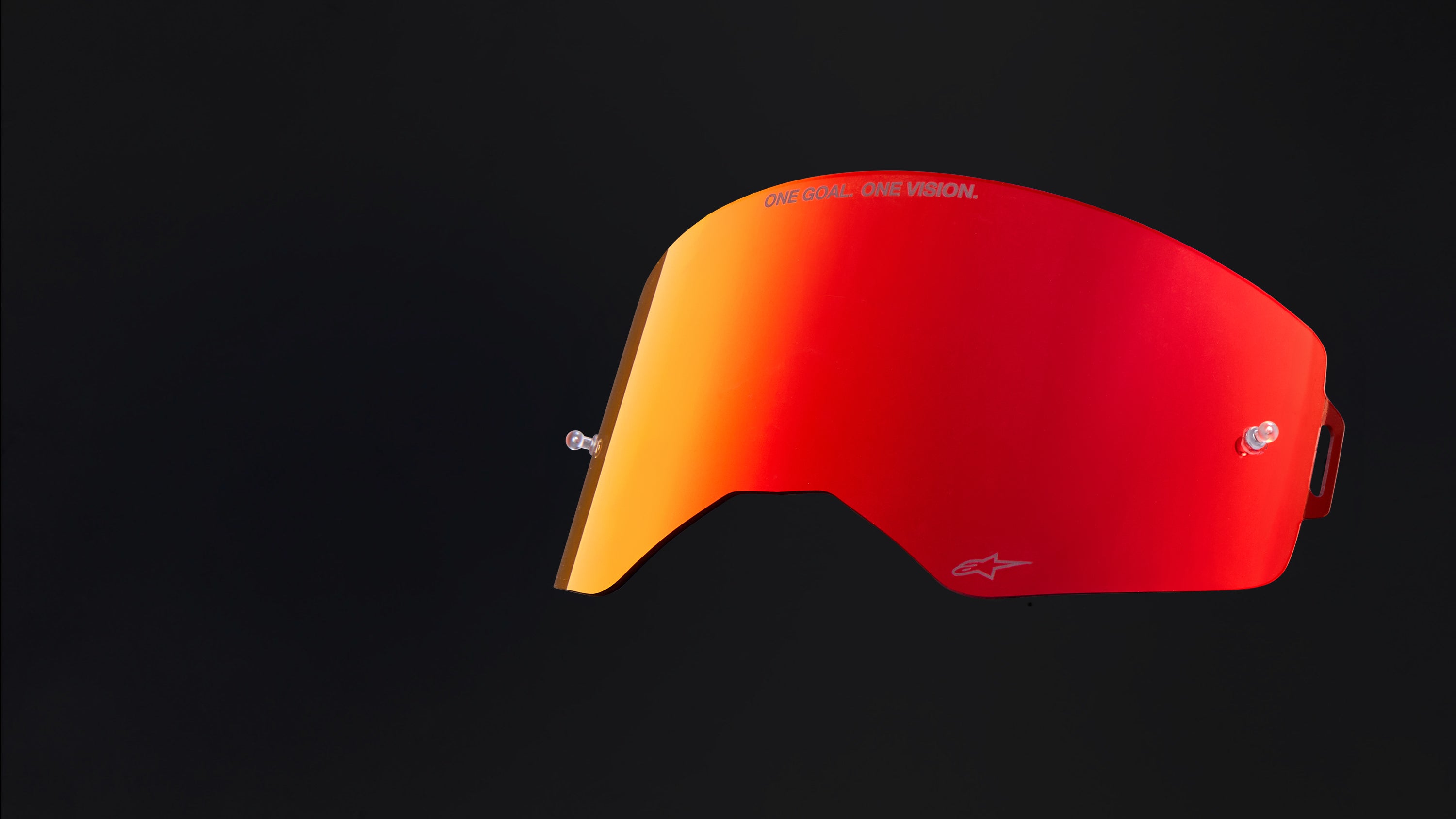 Alpinestars motocross goggle lens, red and orange mirrored finish, featuring the One Goal One Vision motto.