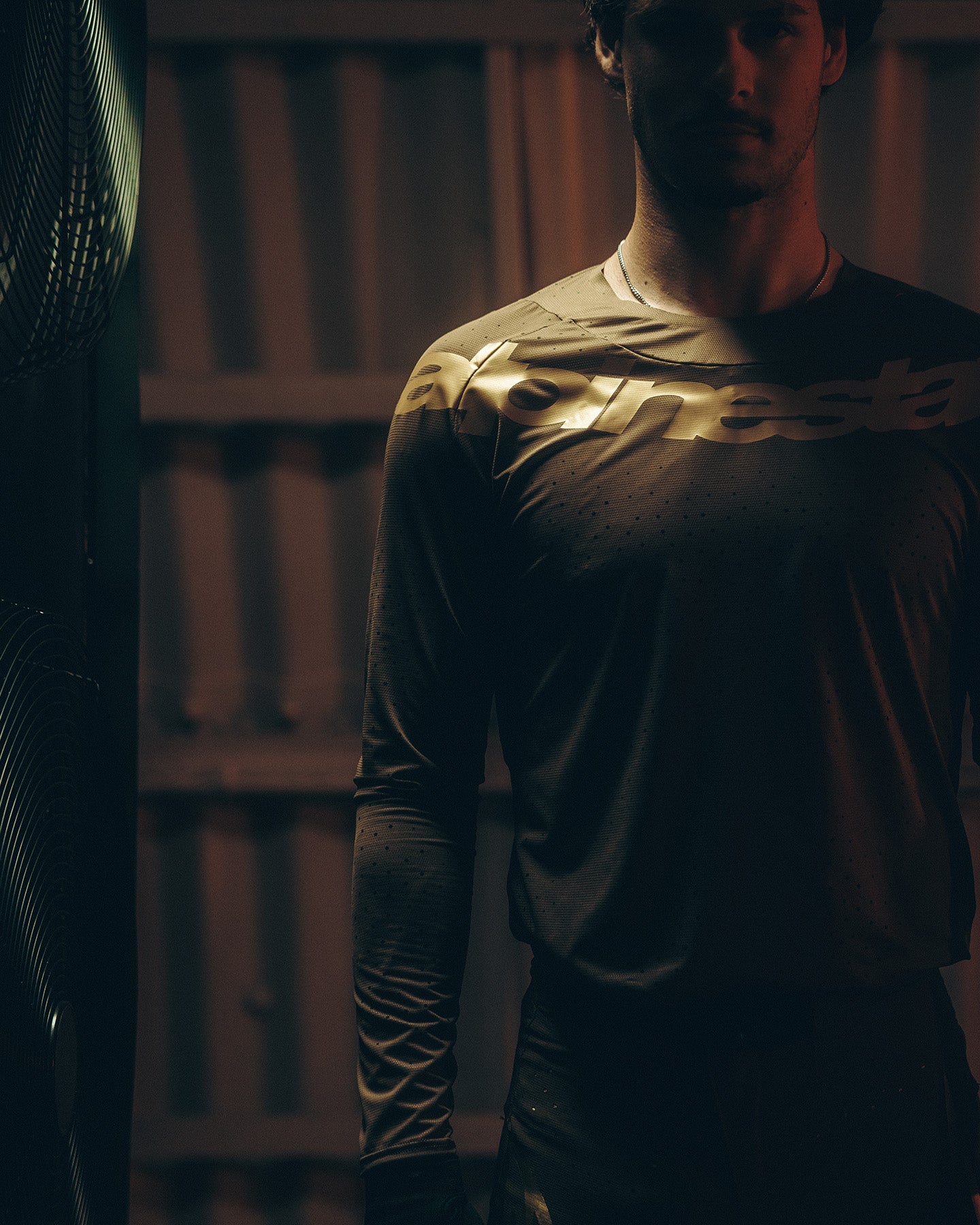 Alpinestars Limited Edition Supertech Air Gold jersey in brown and gold with a metallic chest logo for motocross racing.