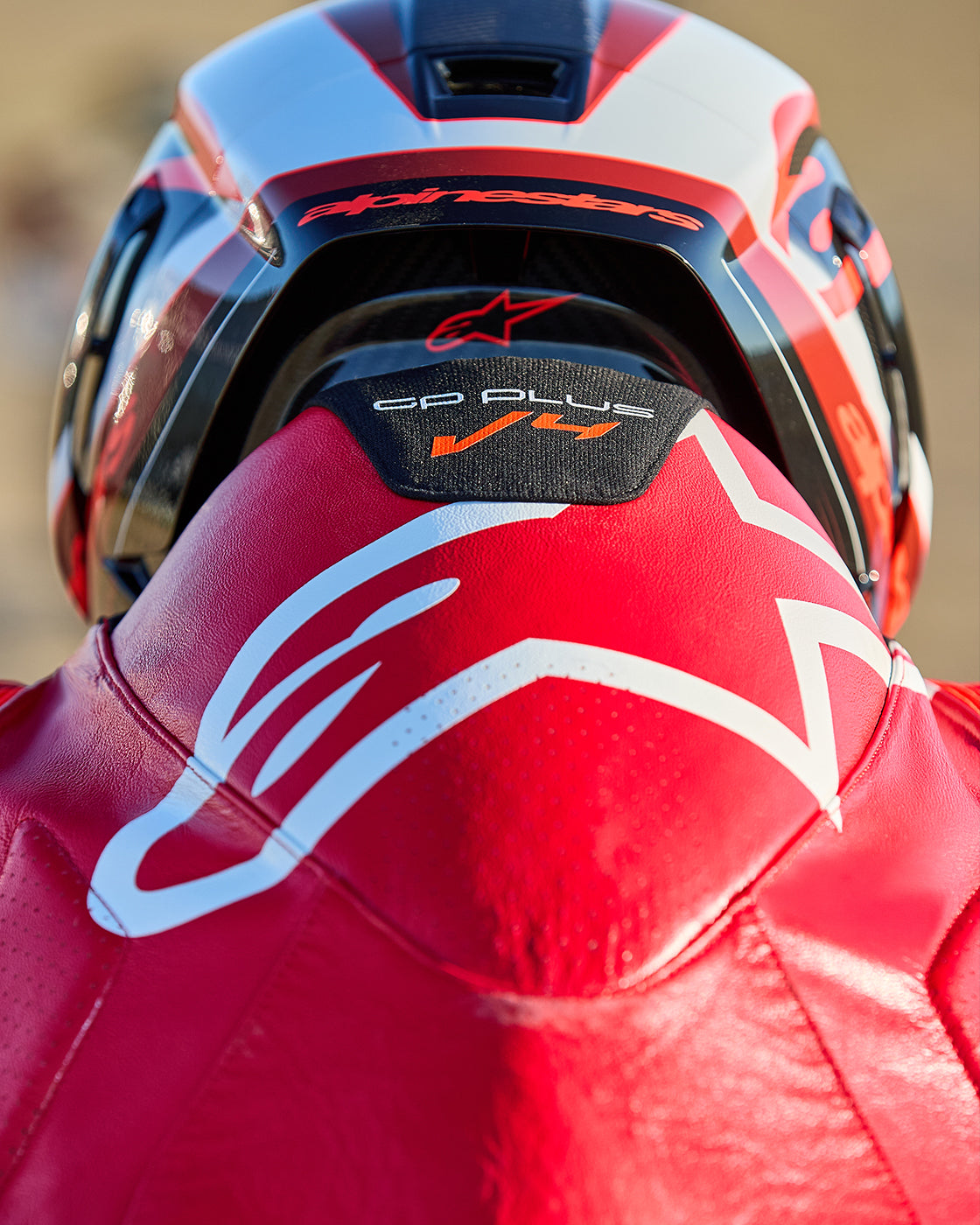 Alpinestars GP Plus V4 Sprint 1PC Leather Suit, red and white aerodynamic hump for motorcycle racing performance.