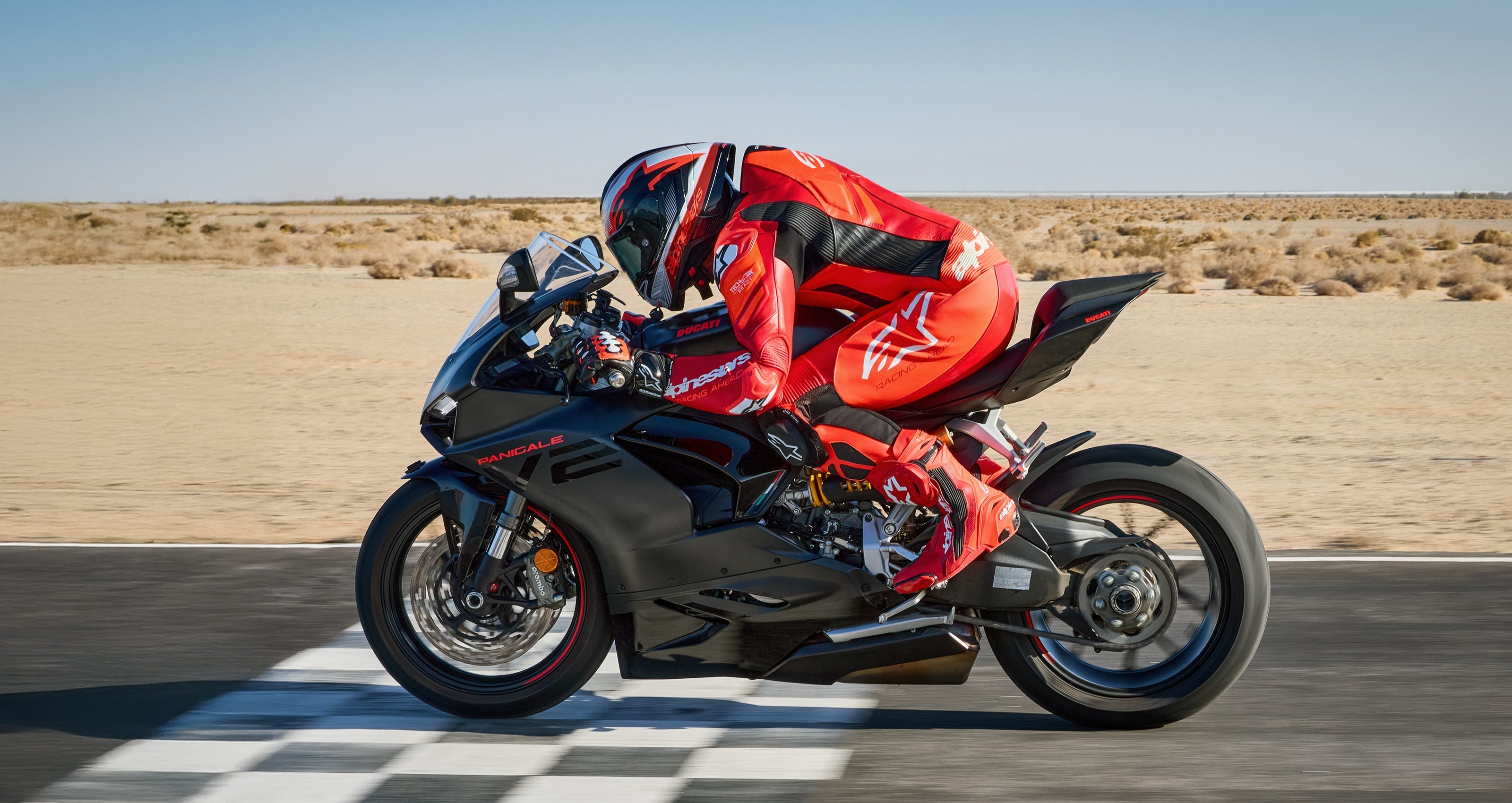 Alpinestars GP Plus V4 Sprint 1PC Leather Suit, Red and White men's racing suit, Tech-Air ready, rider on a black motorcycle.