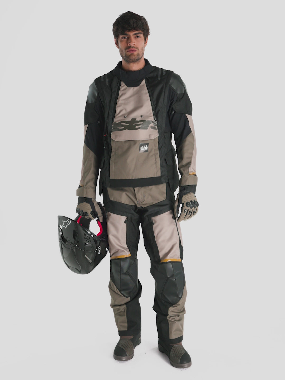 Alpinestars Harok V2 Drystar® Gear Set, men's adventure touring motorcycle gear set in aluminum, walnut, and black, featuring ripstop textile construction, waterproof Drystar lining, and Nucleon Flex Pro armor worn by a model.