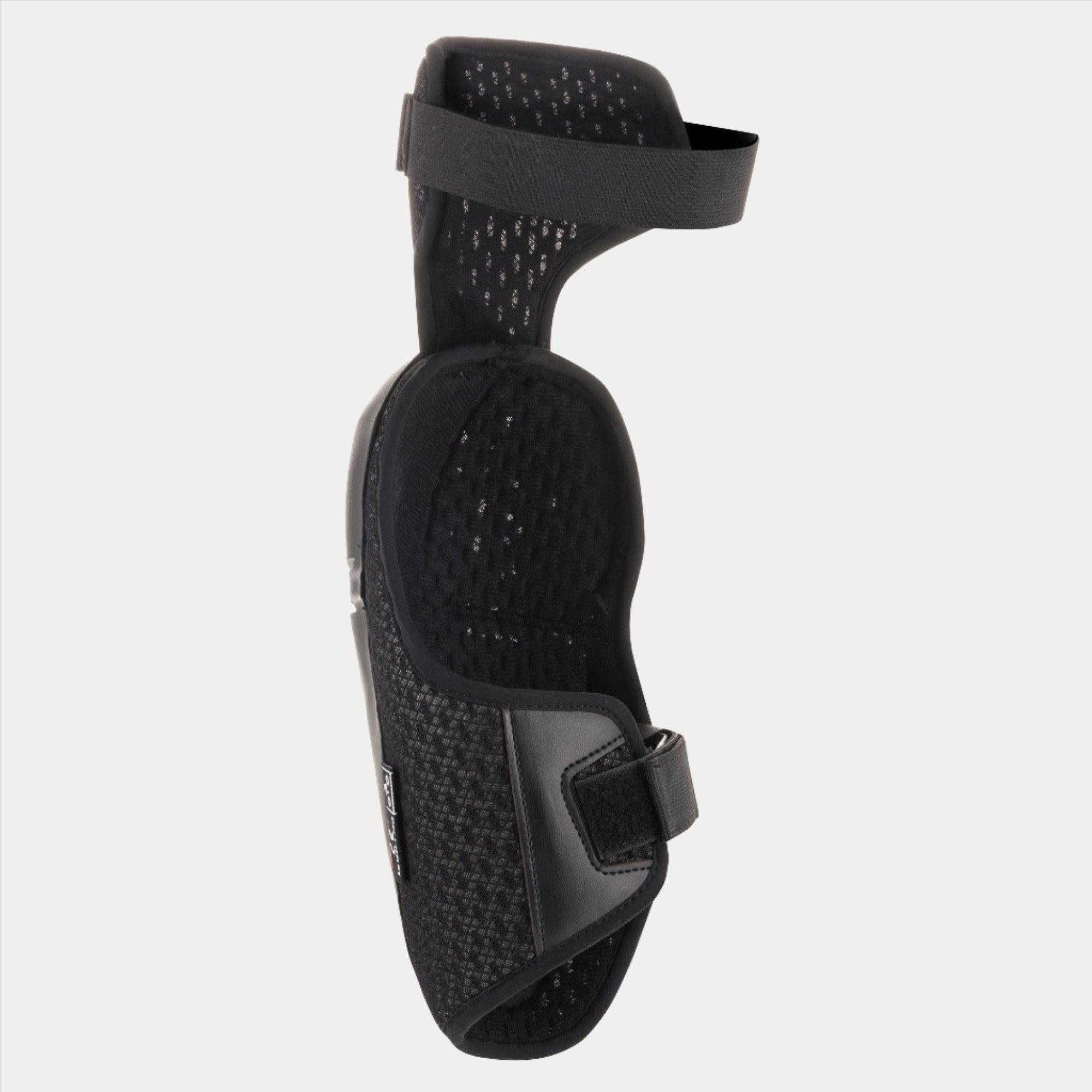 Ginocchiera Alpinestars Youth Bionic Plus, protezione ginocchio per ragazzi, nero, mostra la fodera interna in mesh e il sistema di chiusura a doppia cinghia, design ergonomico per motocross e fuoristrada